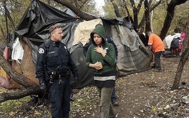 police monitor homeless encampment
